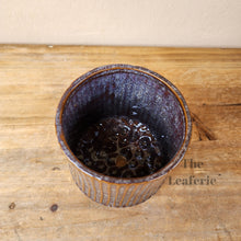 Load image into Gallery viewer, The Leaferie Ide pot. purple ceramic pot with studs at the bottom.