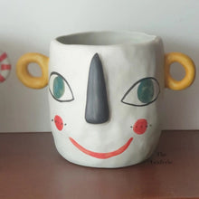 Load image into Gallery viewer, The Leaferie Faccia handmade pot. ceramic face pot. front view of yellow ear