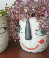 Load image into Gallery viewer, The Leaferie Faccia handmade pot. ceramic face pot. front view of yellow ear with plant