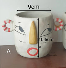 Load image into Gallery viewer, The Leaferie Faccia handmade pot. ceramic face pot. front view of stripey ear and size