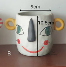Load image into Gallery viewer, The Leaferie Faccia handmade pot. ceramic face pot. front view of yellow ear