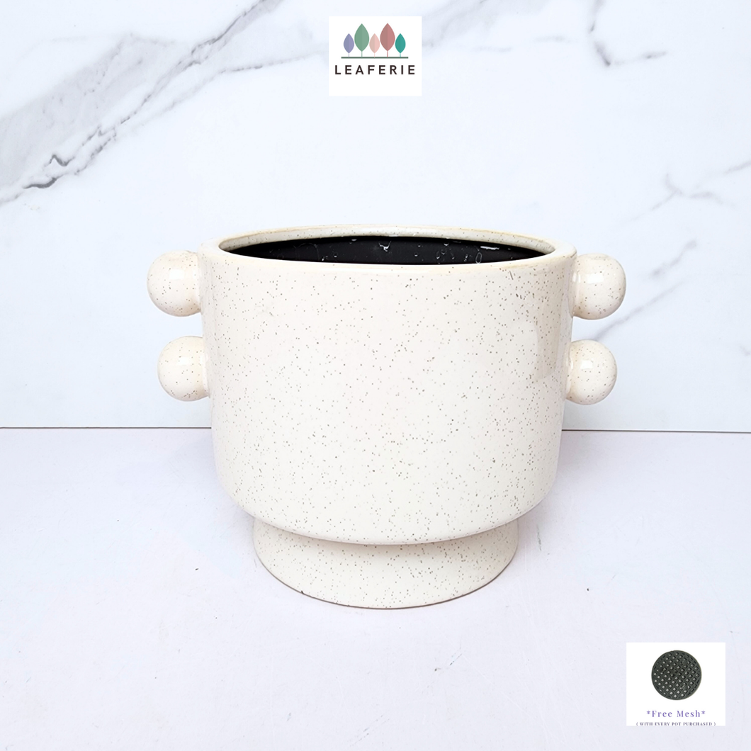 The Leaferie Lyra white ceramic pot with 2 buttons at the side