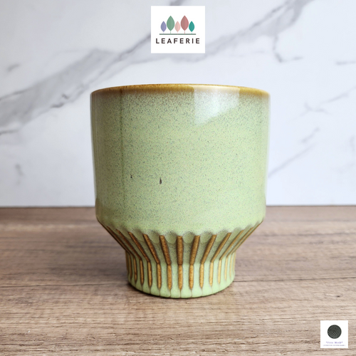 The Leaferie Bairn green flowerpot. ceramic material