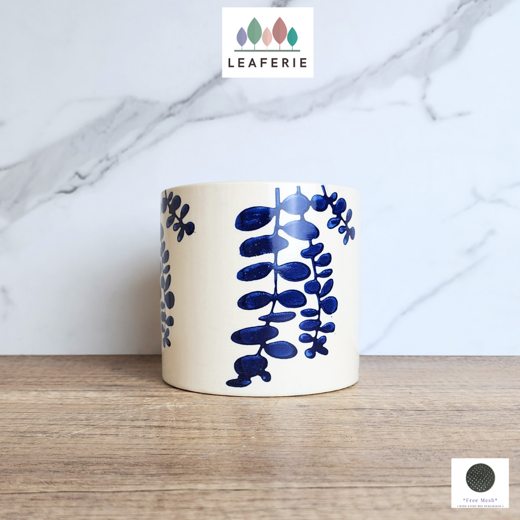 The Leaferie Hamsa blue petals on white ceramic pot.