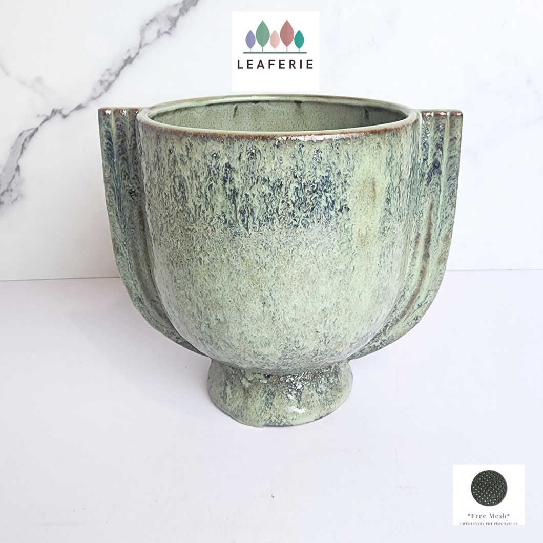 The Leaferie Torin green flowerpot. ceramic material