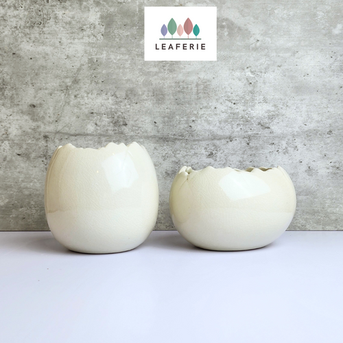 The Leaferie Maja Egg flowerpot. cream white ceramic pot. front view of designs