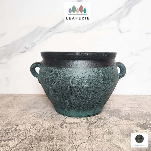 The Leaferie Phelan blue and black pot with ear. ceramic material