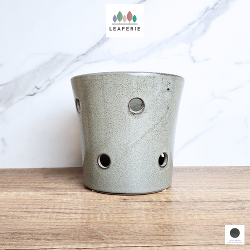 The Leaferie Limbadi orchid pot with holes. ceramic material