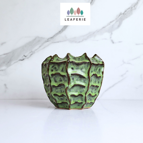 The Leaferie Tova pot. green ceramic pot with groves. front view
