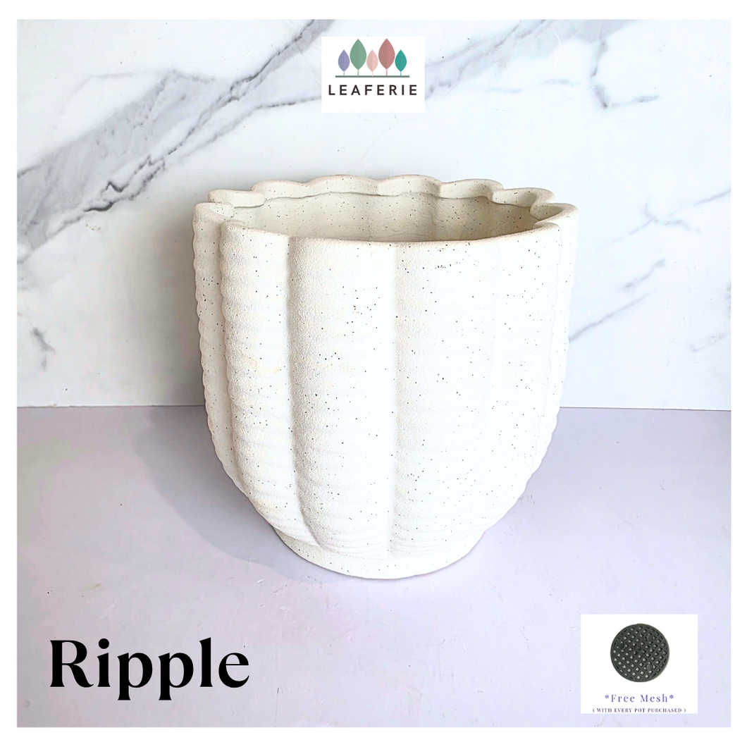 Ripple White ceramic planter with wavy texture on a marble background, featuring the Leaferie brand.
