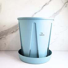 Load image into Gallery viewer, Light blue plastic planter with a matching saucer , featuring the LEAFERIE brand.
