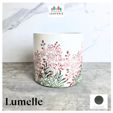 Load image into Gallery viewer, Lumelle Ceramic planter with floral design on a gray surface, featuring the brand 'LEAVERIE'.

