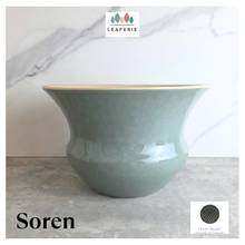 Load image into Gallery viewer, Soren Green ceramic vase with gold rim on a light gray surface, branded 'LEAFERIE'.
