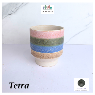 Tetra Ceramic cup with multicolored stripes on a light background, featuring the brand 'LEAFAERIE'.