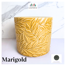 Load image into Gallery viewer, Marigold Yellow ceramic pot with leaf pattern on a marble background, featuring the Leaferie brand.
