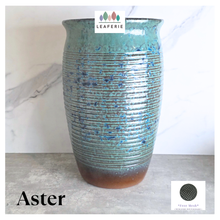 Load image into Gallery viewer, Aster Tall Decorative pot with speckled pattern on a marble surface, branded 'LEAFERIE'.

