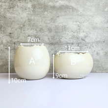 Load image into Gallery viewer, The Leaferie Maja Egg flowerpot. cream white ceramic pot. front view of designs and size
