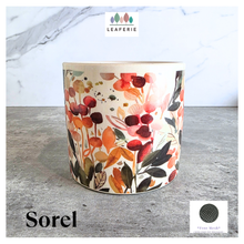 Load image into Gallery viewer, Sorel Floral-patterned candle with 'LEAFERIE' branding on a marble surface
