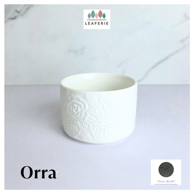 Orra White ceramic pot with textured design on a light gray background, featuring the brand 'LEAFERIE'.