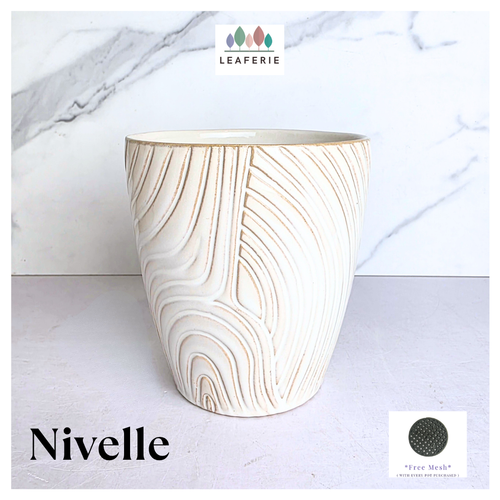 Nivelle Ceramic planter with marbled design on a marble background, featuring the brand 'LEAFAERIE'.