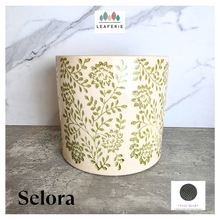 Load image into Gallery viewer, Selora Decorative planter with green floral pattern on a gray surface, featuring the brand 'LEAFERIE'.
