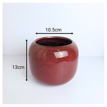 Load image into Gallery viewer, Soraya ceramic pots, one red and one green, with &#39;LEAFERIE&#39; branding on a white background.

