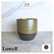 Load image into Gallery viewer, Lowell pot with gold and black design on a gray surface, featuring the Leaferie brand.
