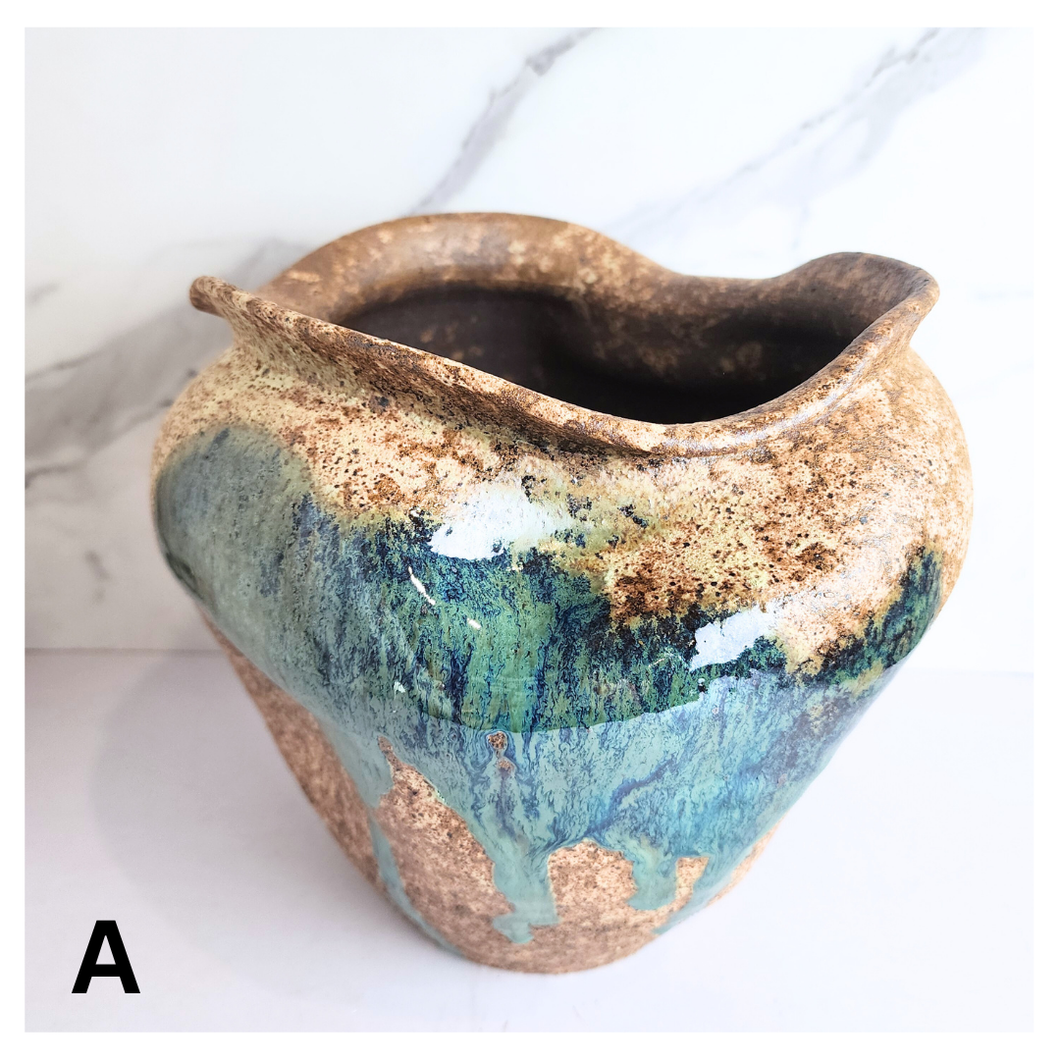 Raku ceramic vase with gold and blue glaze on a white background, featuring the Leaferie brand.