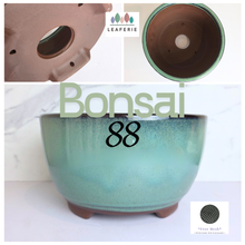Load image into Gallery viewer, Teal ceramic bonsai pot with 'Bonsai 88' text on a white background, featuring the Leaferie brand.

