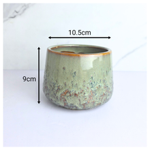 Load image into Gallery viewer, Tero Green ceramic cup with speckled texture on a white background, featuring the LEAFAERIE brand.
