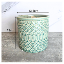 Load image into Gallery viewer, Caleb Teal patterned ceramic planter on a gray surface with 'LEAFERIE' 
