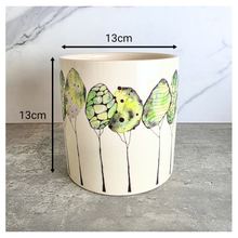 Load image into Gallery viewer, Folia Ceramic planter with butterfly design on a gray surface, featuring the brand 'LEAFAERIE'.
