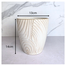 Load image into Gallery viewer, Nivelle Ceramic planter with marbled design on a marble background, featuring the brand 'LEAFAERIE'.

