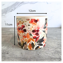 Load image into Gallery viewer, Sorel Floral-patterned candle with 'LEAFERIE' branding on a marble 
