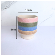 Load image into Gallery viewer, Tetra Ceramic cup with multicolored stripes on a light background, featuring the brand &#39;LEAFAERIE&#39;.
