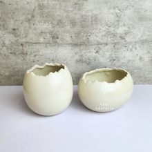 Load image into Gallery viewer, The Leaferie Maja Egg flowerpot. cream white ceramic pot. front view of designs
