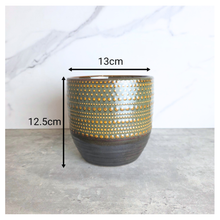 Load image into Gallery viewer, Lowell pot with gold and black design on a gray surface, featuring the Leaferie brand.
