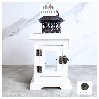 Luma White lantern with black top on a gray surface, Leaferie brand visible