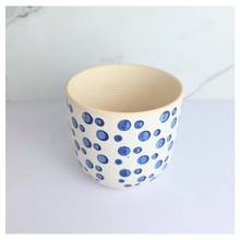 Load image into Gallery viewer, Cirra White ceramic planter with blue dot pattern on a light gray background, featuring the brand &#39;LEAFAERIE&#39;.
