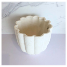 Load image into Gallery viewer, Ripple White ceramic planter with wavy texture on a marble background, featuring the Leaferie brand.
