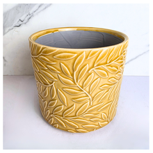 Load image into Gallery viewer, Marigold Yellow ceramic pot with leaf pattern on a marble background, featuring the Leaferie brand.

