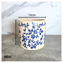 Load image into Gallery viewer, Caelis Ceramic planter with blue floral pattern on a marble surface, featuring the brand 'LEAFAERIE'.
