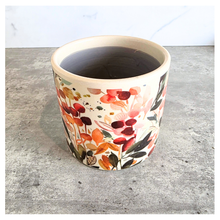 Load image into Gallery viewer, Sorel Floral-patterned candle with 'LEAFERIE' branding on a marble 
