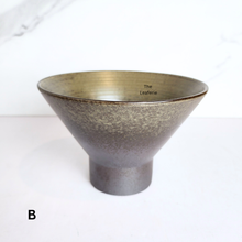Load image into Gallery viewer, Bronze-colored planter with &#39;The Leaferie&#39; branding on a white background
