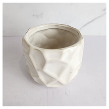 Load image into Gallery viewer, White ceramic planter with geometric design on a light gray background
