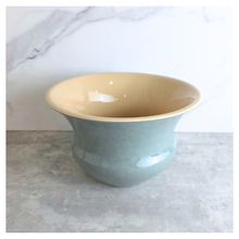 Load image into Gallery viewer, Soren Green ceramic vase with gold rim on a light gray surface, branded 'LEAFERIE'.
