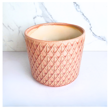Load image into Gallery viewer, Petalia Decorative pink pot with geometric pattern on a marble background, featuring the brand 
