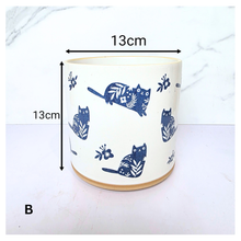 Load image into Gallery viewer, Niko cat Navy blue mug with white cat designs on a white background, featuring the brand &#39;LEAFERIE&#39;.
