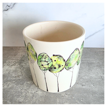 Load image into Gallery viewer, Folia Ceramic planter with butterfly design on a gray surface, featuring the brand 'LEAFAERIE'.
