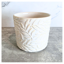 Load image into Gallery viewer, Silas White ceramic planter with leaf pattern on a gray surface, branded 'LEAFERIE'.
